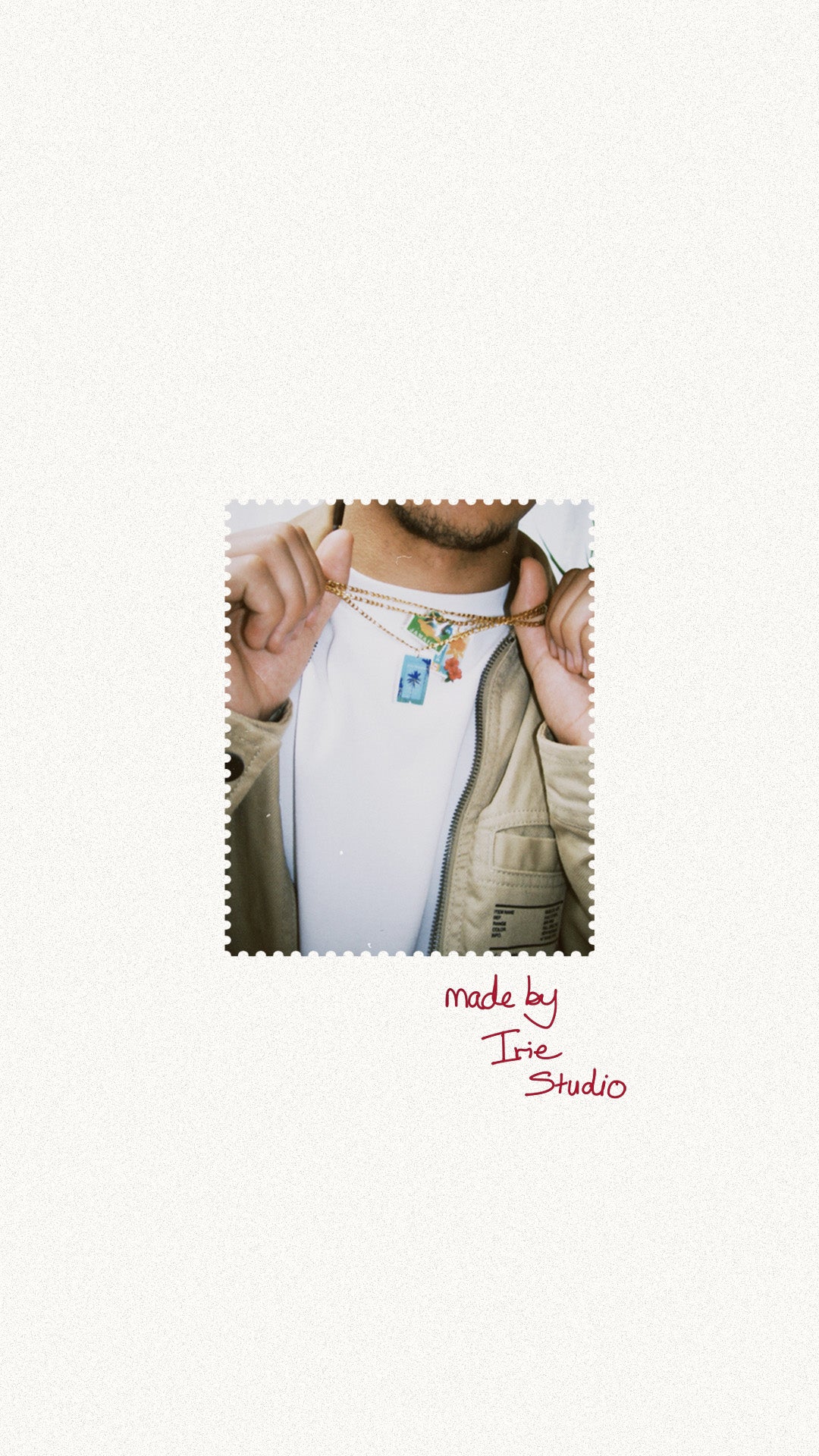 Person wearing a white shirt  and  Irie Studio Caribbean inspired necklaces charms.